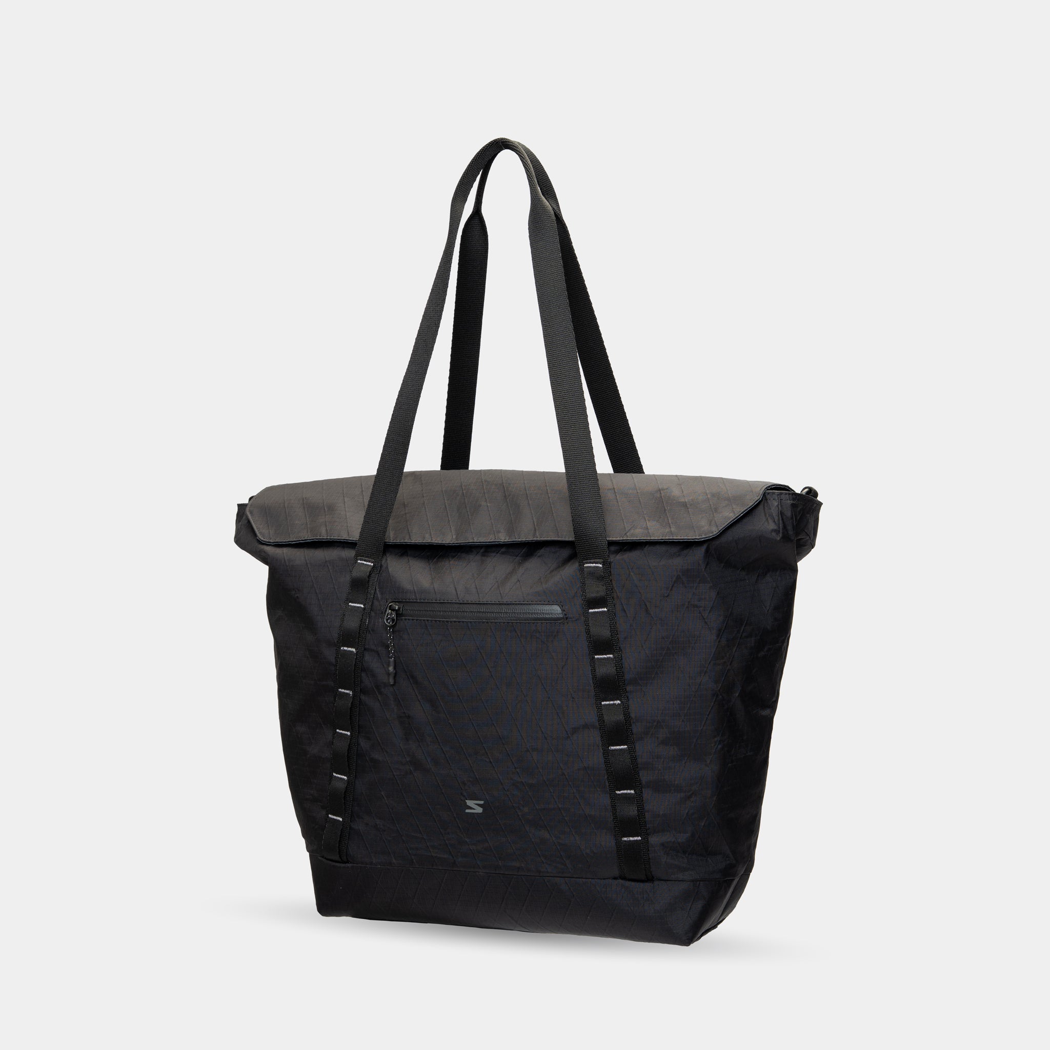 All-black waterproof tote for photographers and creatives. Converts from work to weekend mode.