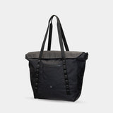 All-black waterproof tote for photographers and creatives. Converts from work to weekend mode.
