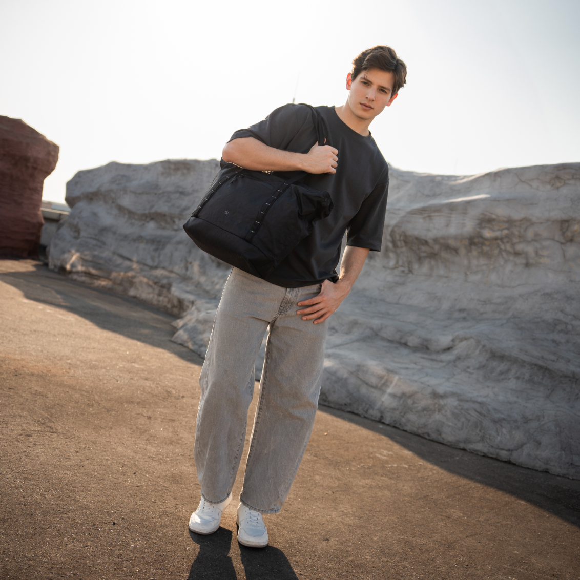 All-black waterproof tote for photographers and creatives. Converts from work to weekend mode.