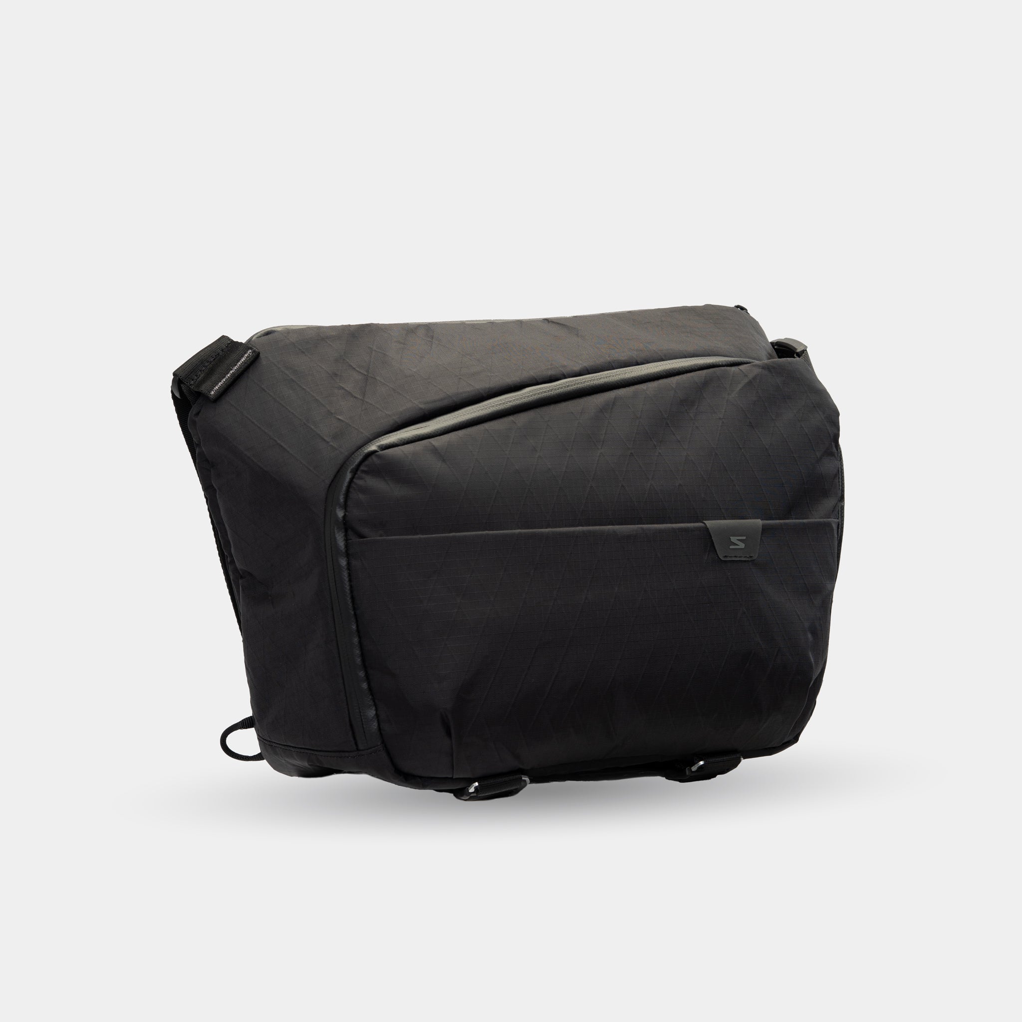 All-black sling bag for camera, laptop, and travel gear