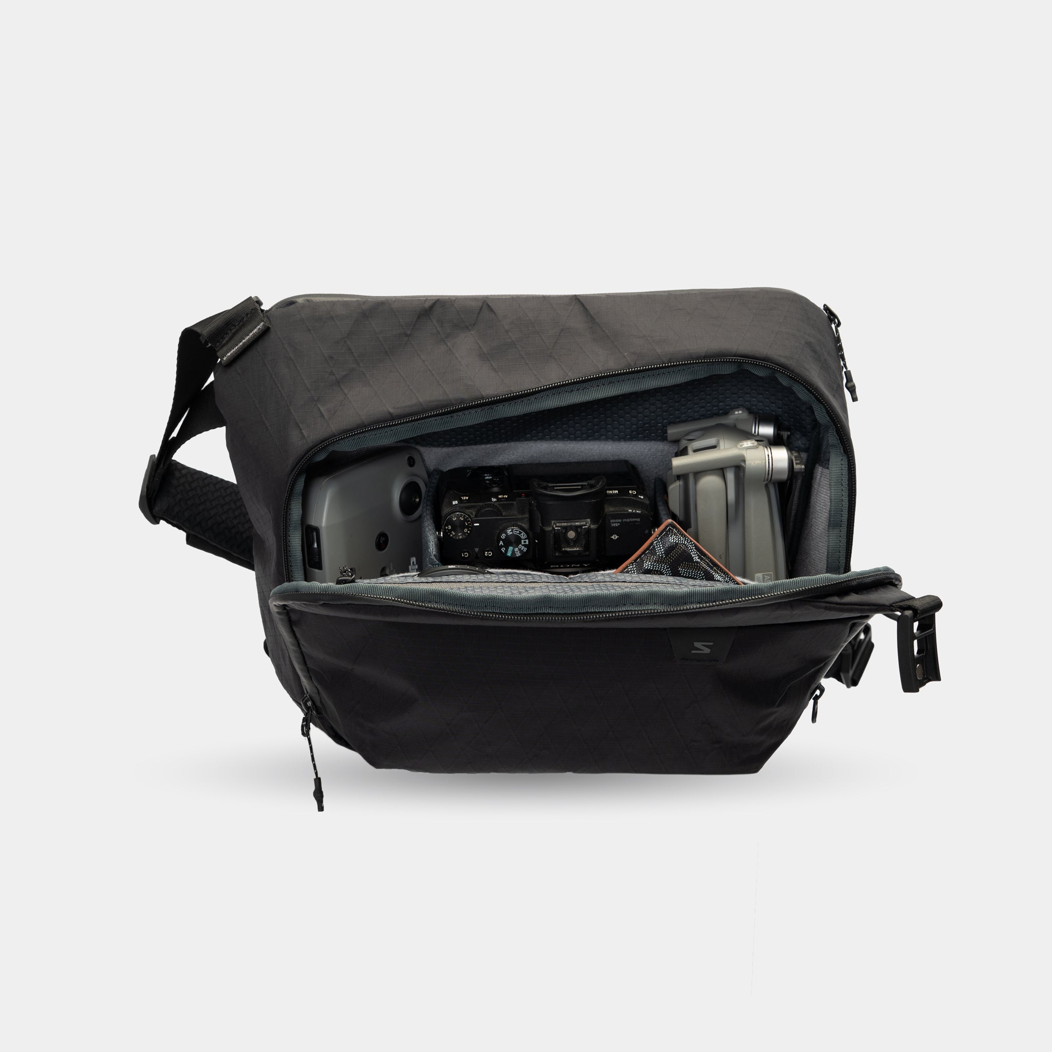 Compact sling bag with laptop and camera compartments
