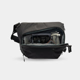 Compact sling bag with laptop and camera compartments
