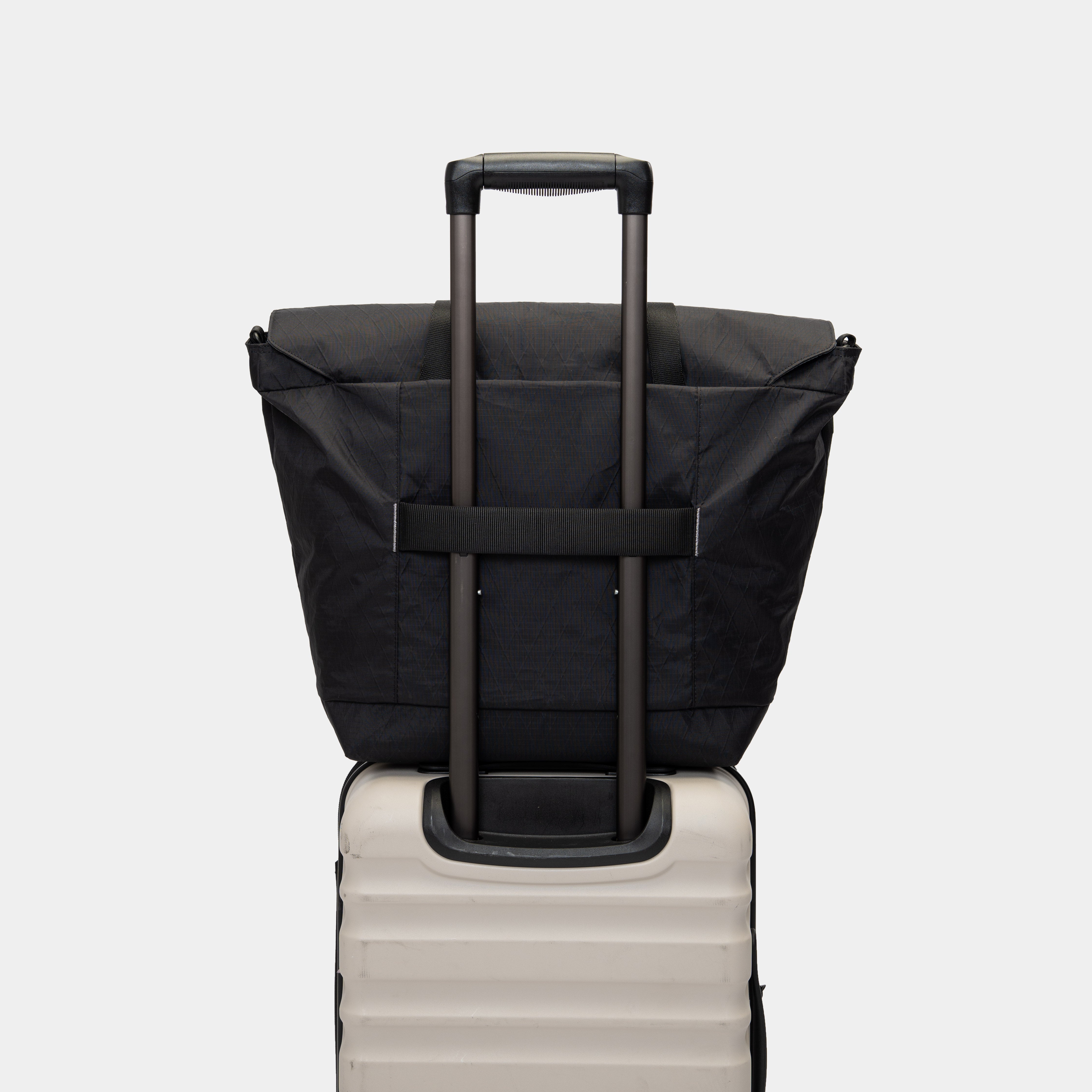 Tote with padded straps and luggage passthrough. Ideal for carry-on and travel days.