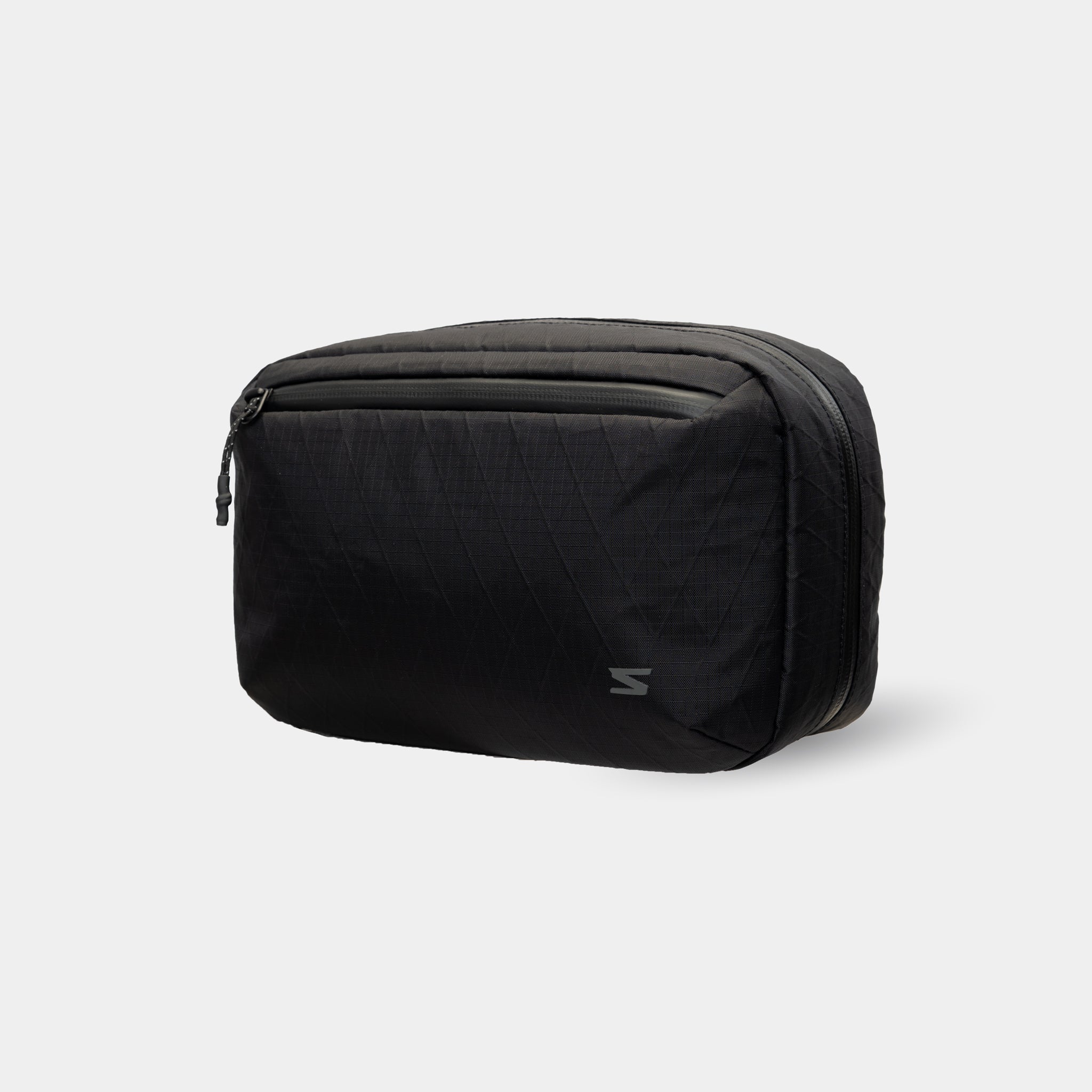 Waterproof tech sling with removable strap. Ideal for travel, commuting, or set days.
